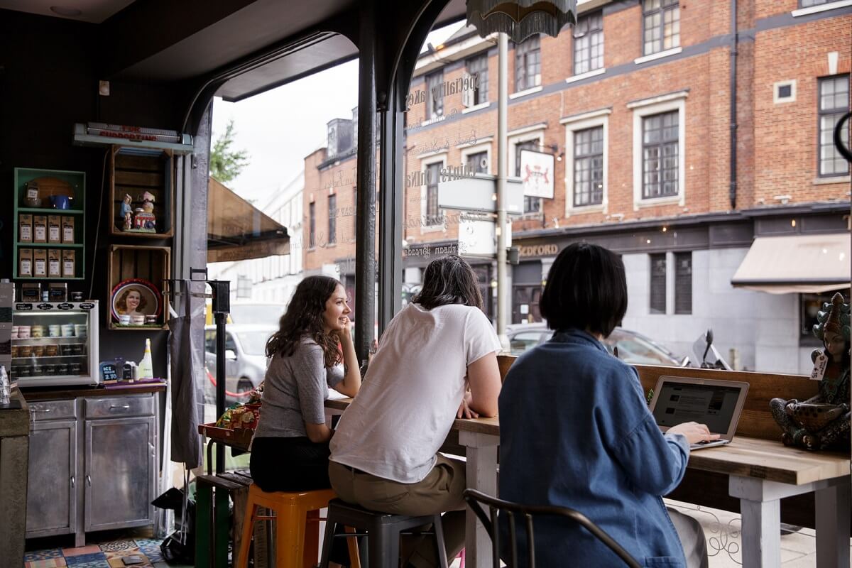 esquires organic coffee shop customers sitting at window