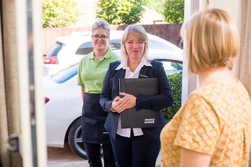 Merry Maids franchisee with cleaner meeting new client