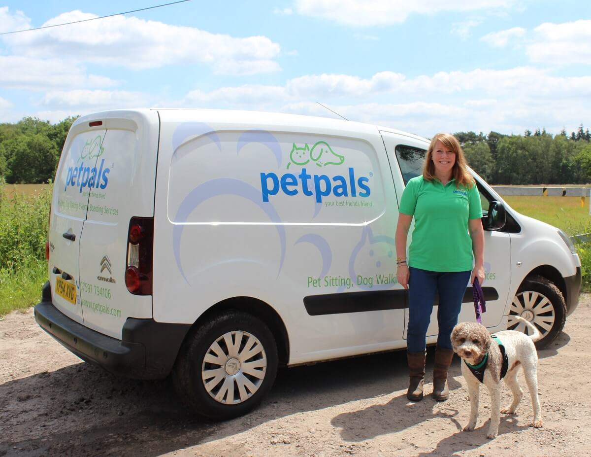 Petpals franchisee with her dog beside a van