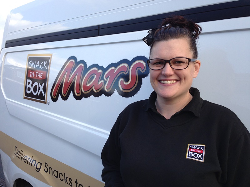 Snack in the box franchisee standing next to her van