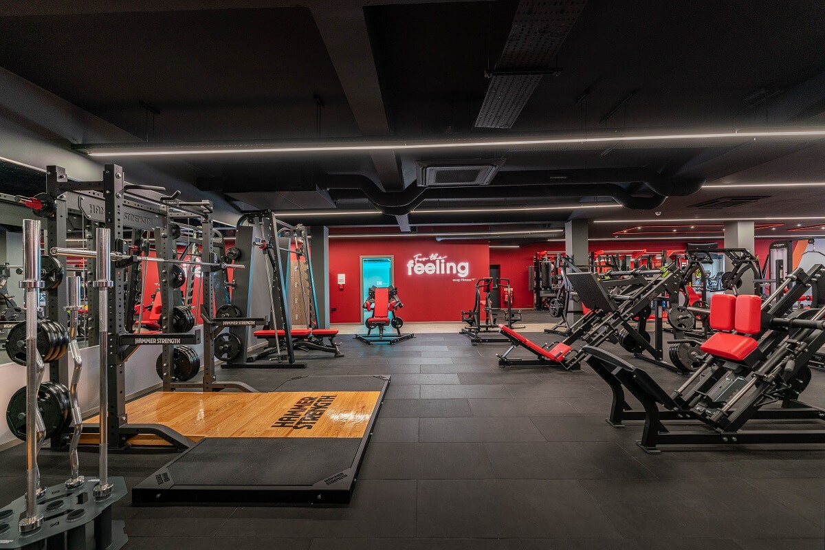 snap fitness gym goer working out on an exercise bike