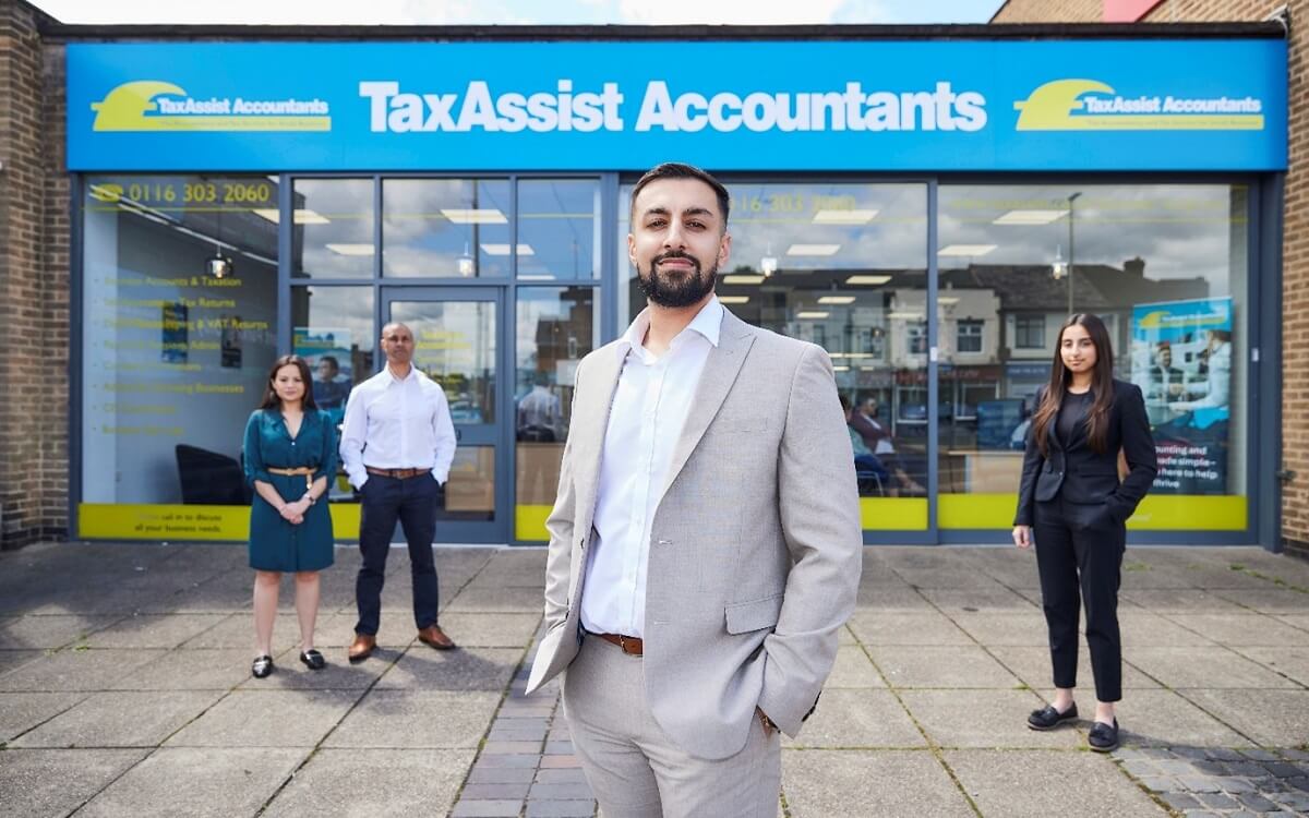 TaxAssist franchisee standing infront of store with staff members