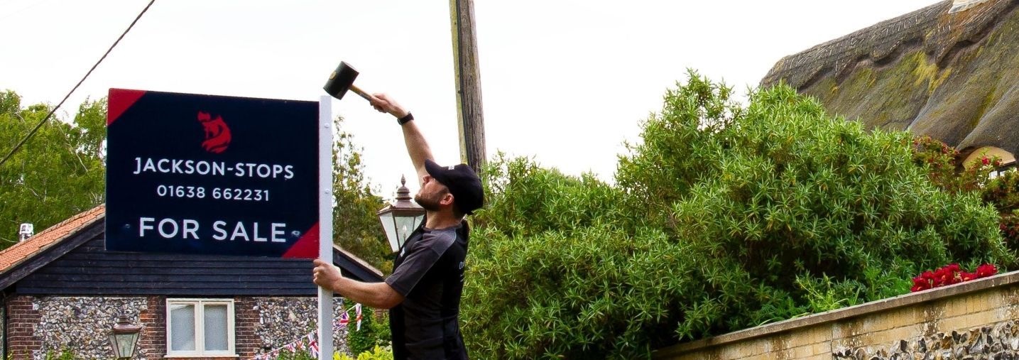 man erecting a sign