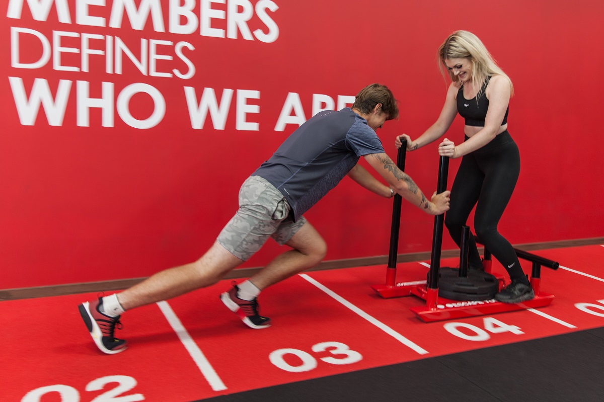 snap fitness gym goer working out with weights